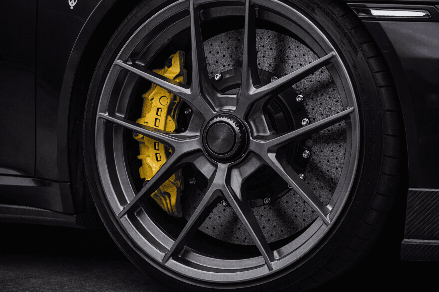Centerlock wheel macro with ceramic brake disc and eight piston brake caliper on Porsche 991.2 Turbo S