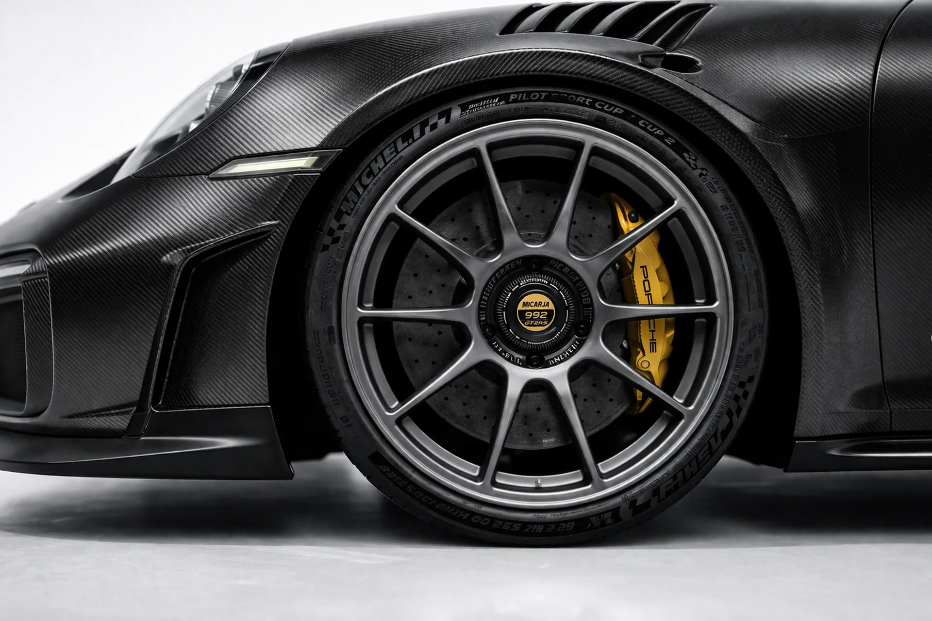 Porsche GT2 RS coachbuild wheel detail with carbon bodywork and yellow brake caliper