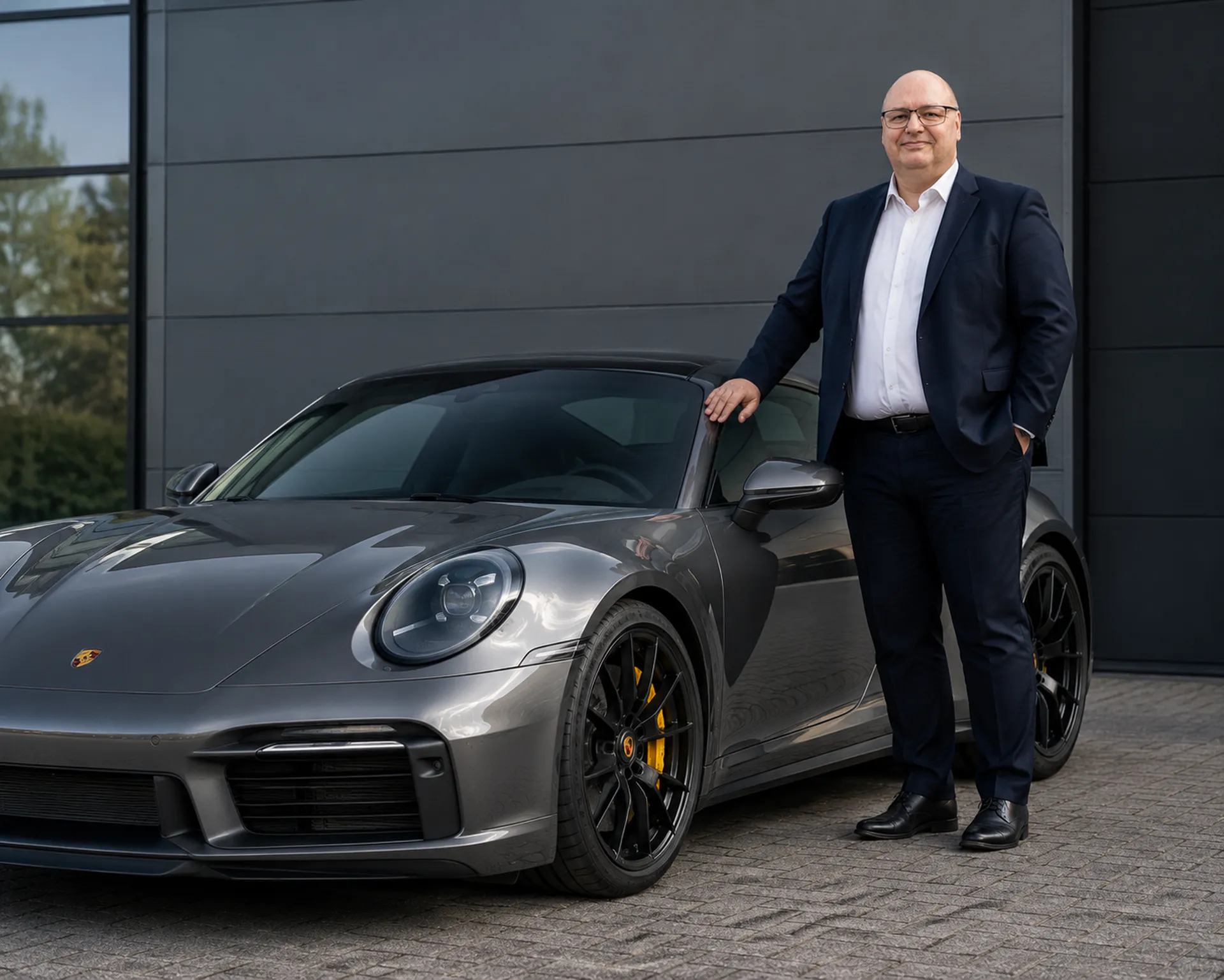 Jan Engel, founder of Micarja Racing, beside a Porsche